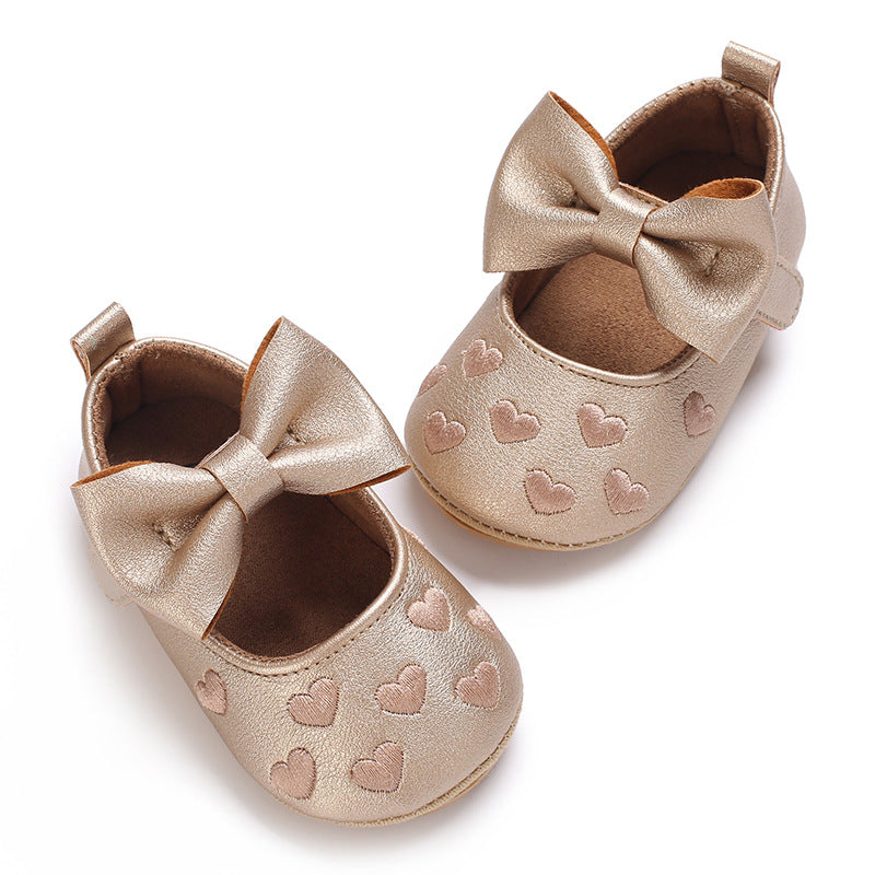 Zapatos Dorados con Lazo y Corazones – Colección Festiva para Bebé Niña Imagen secundaria del producto
