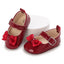 Zapatos de Charol Rojo con Hebilla y Lazo – Colección Navidad y Eventos